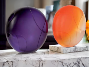 Purple and orange orbs on a marble counter